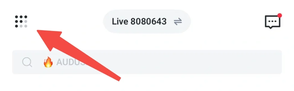 Header with a left grid menu icon, centered 'Live 8080643' badge, and right chat icon showing a red notification dot; below is a search bar reading '🔥 AUDUS'; a red arrow overlays the left icon.